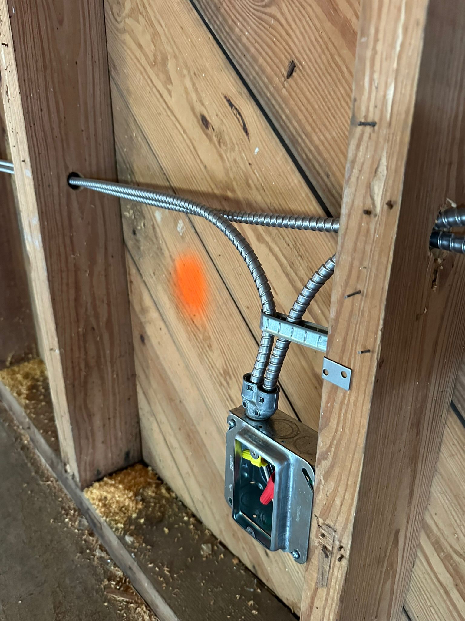 Professional electrical rough-in installation by Current Electrical FL featuring secure conduits and outlet boxes within residential wooden framing.